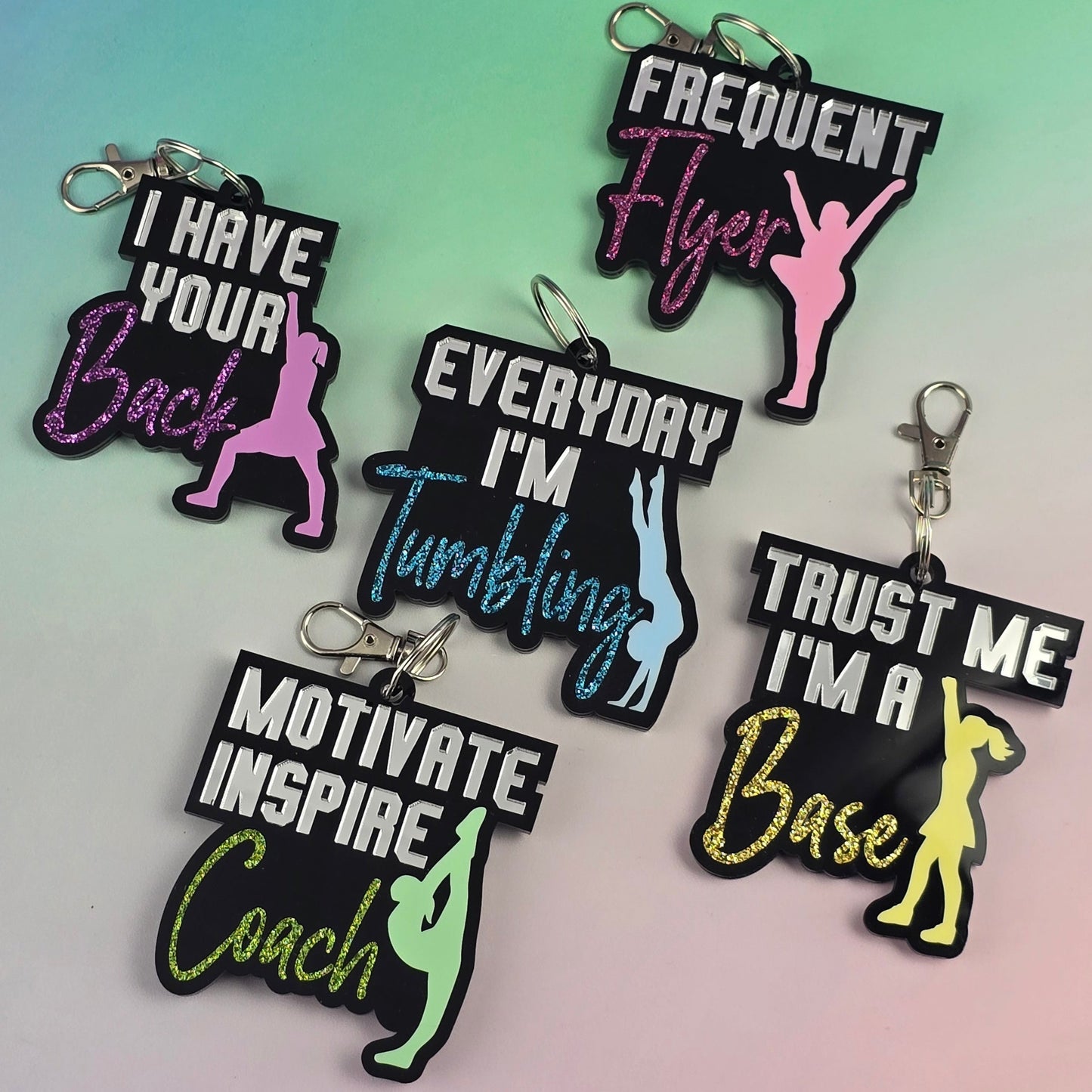 Set of motivational keychains on a gradient background
