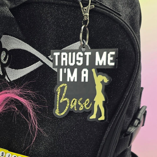Black backpack with colorful designs and text on a gradient background
