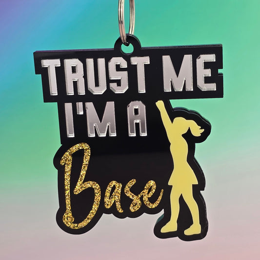 Keychain with 'Trust Me, I'm a Base' text and graphic on a gradient background