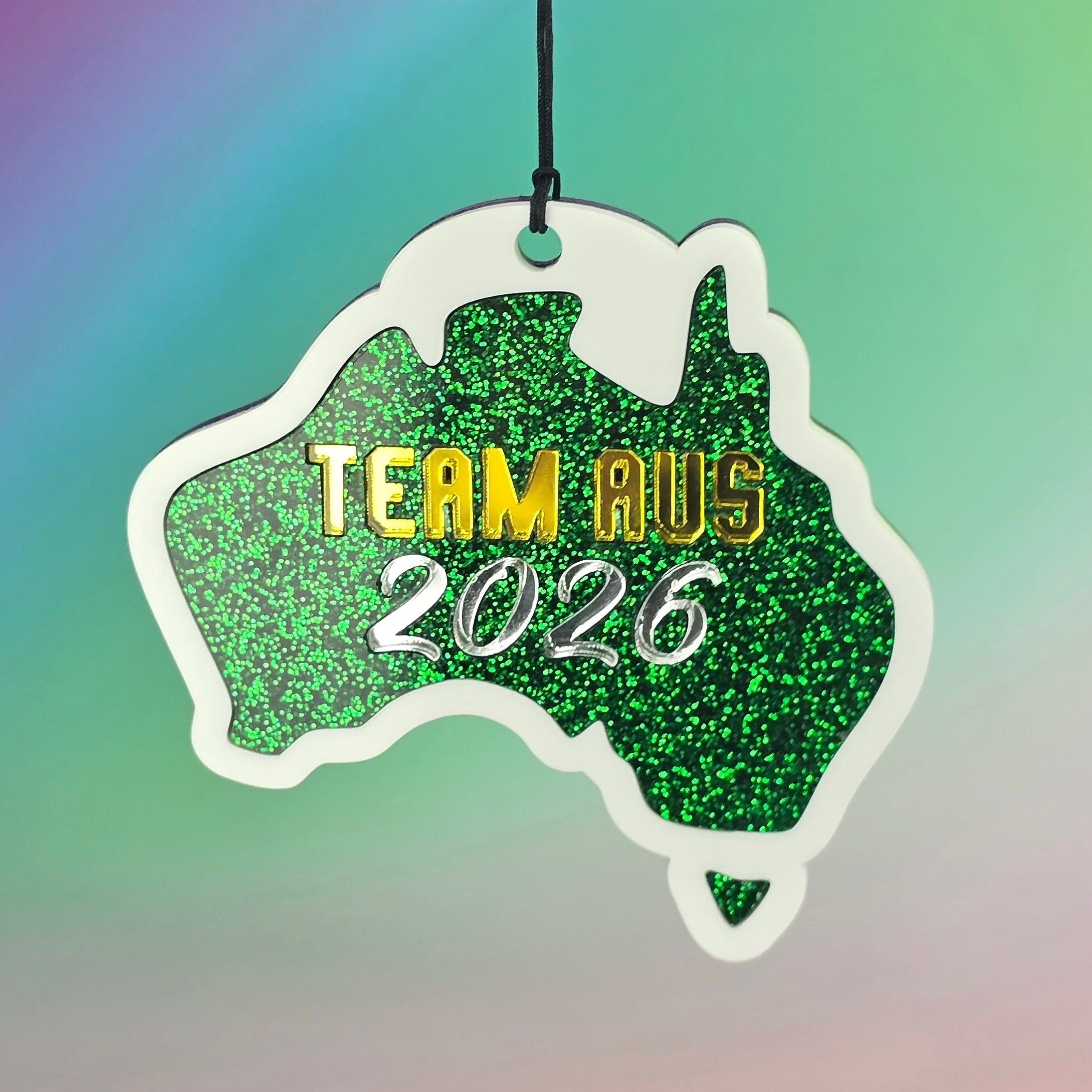 Green glittery badge with 'Team Aus 2026' text on a colorful gradient background Team Australia Bag Tag Keyring